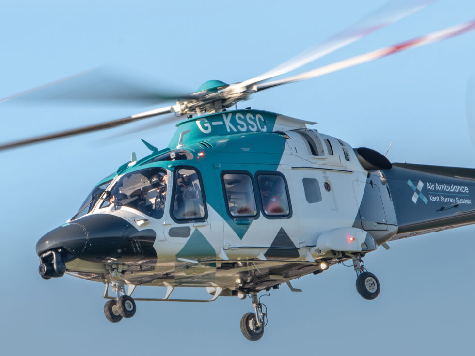 KSS Air Ambulance Charity - Kent Surrey Sussex. Air ambulance hovering in the sky. KSS Air Ambulance Charity - Kent Surrey Sussex. Air ambulance hovering in the sky.