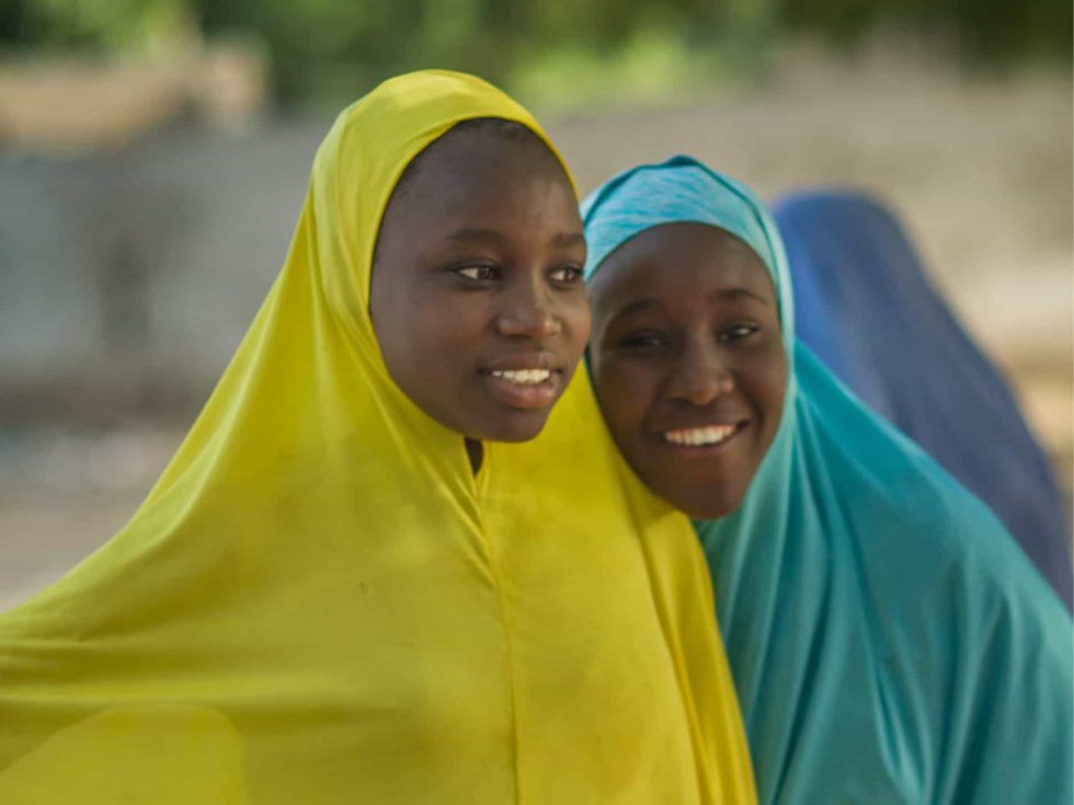 MAG - Freeing People from Fear MAG - Freeing people from fear. Two young girls wearing brightly coloured covering smiling for the camera.